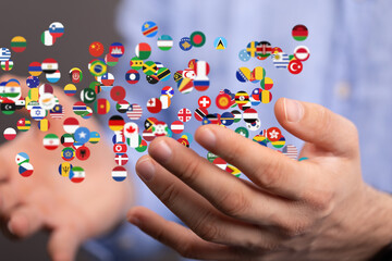 Image of hands gently cradling numerous flags, symbolizing global unity and international collaboration.