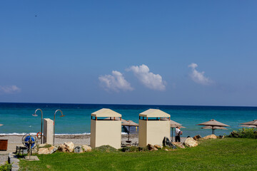 Stunning beach scene with cabanas, turquoise water, and a clear blue sky. Perfect for summer vacation themes.