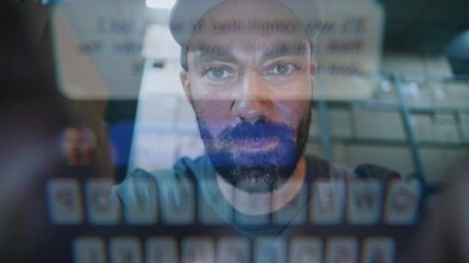 POV from Smartphone Screen: Male Worker Using Phone, Chatting in Social Networks. In the Background, Diverse Employees Carrying Cardboard Boxes with Online Orders in Logistics Warehouse at Night. - Powered by Adobe