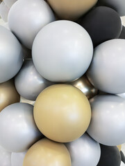 Background of balloons of different sizes: grey, white, black.