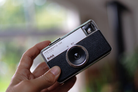 Close Up of Kodak Instamatic 133 Vintage Film Camera Held in Hand