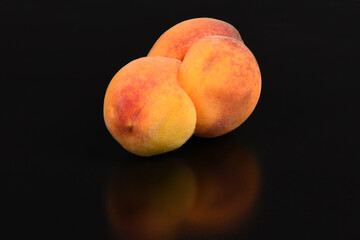 Ugly peach. Two peaches fused into one on a black background.