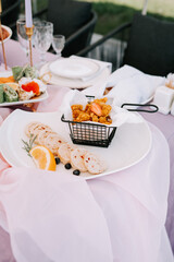 Elegant dining experience with gourmet appetizers on a decorated table outdoors
