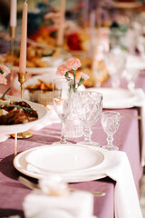 Elegant dining setup with floral accents and fine tableware at a festive gathering
