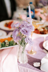 Elegant table setting with lavender flowers and delicious food during a festive gathering