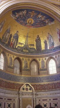 Byzantine-style golden mosaic apse with Christ Pantocrator, apostles, and symbolic animals in ornate religious church interior decoration