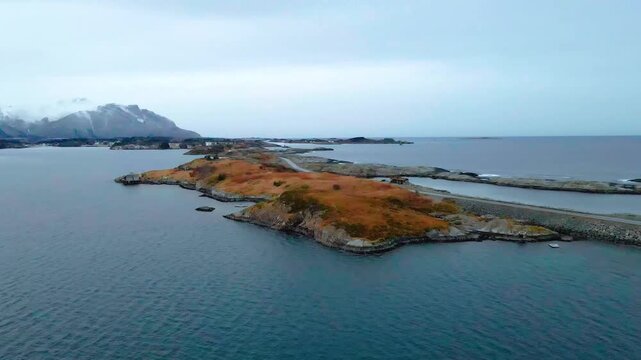 aerial footage showcasing the iconic Atlantic Ocean Road Atlanterhavsveien in Norway, a coastal highway connecting islands with picturesque bridges, surrounded by the rugged beauty of the Norwegian la