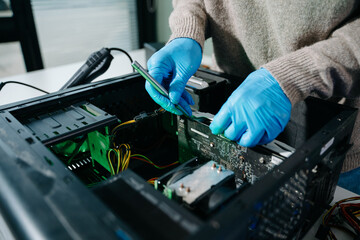 Computer technician in gloves safely repairing desktop hardware. Close-up view of hands fixing GPU and motherboard inside open PC case. Perfect for tech and repair concepts.