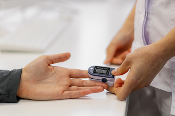 Health check with a pulse oximeter during a routine medical examination in a clinical setting