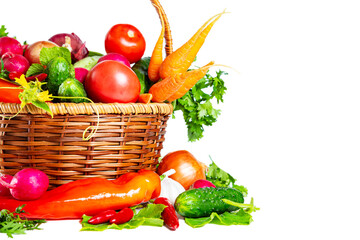 Fresh shiny different vegetables in a wicker basket. Isolated on white background.