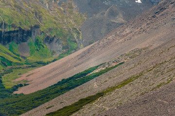 Narrow mountain pass framed by towering glaciers and rugged cliffs