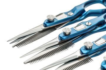 Artfully arranged professional hair cutting scissors displayed on a clean surface highlighting their intricate design and vibrant blue accents isolated on transparent background