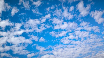 clear blue sky covered with small white clouds