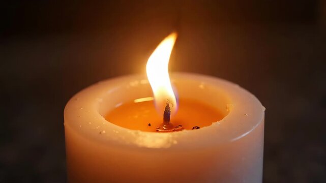 burning candle on a dark background