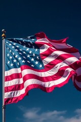 Obraz premium Waving American flag against blue sky stars and stripes