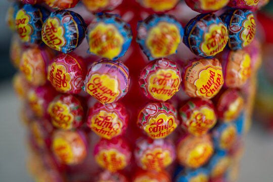 Colorful Chupa Chups lollipops stacked pyramidal, displaying brand's vibrant flavor range on clean background