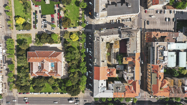 Aerial view of Zagreb's urban tapestry unfolds, with the red-tiled roofs of buildings contrasting against the verdant green spaces and orderly rows of parked cars., Zagreb, Zagreb, Croatia.