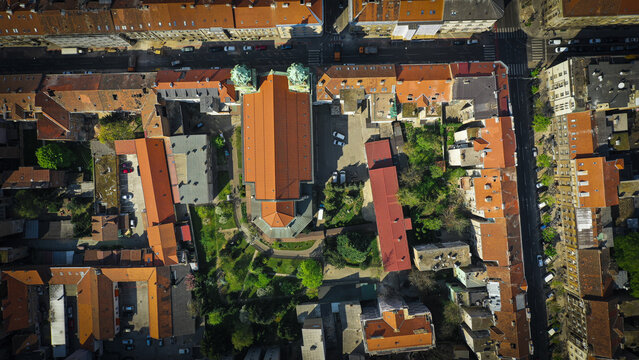 Aerial view of the Zagreb Palmoti&Auml;&Dagger;eva church striking orange rooftop contrasting with surrounding buildings and green spaces, Zagreb, Zagreb, Croatia.