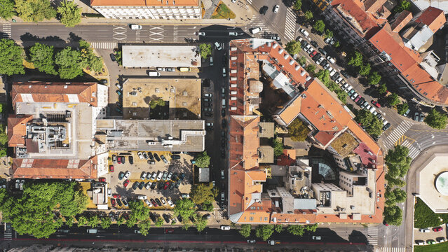 Aerial view of terracotta rooftops and tree-lined streets create a vibrant urban tapestry, contrasting with the orderly rows of parked cars, Zagreb, Zagreb, Croatia.
