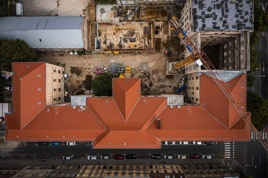 Aerial view of the striking orange rooftops contrasting with the construction site and the surrounding buildings near the crosswalk, Zagreb, Zagreb, Croatia.