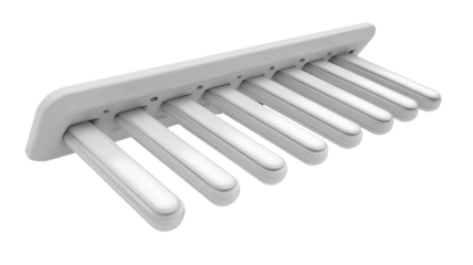White, rectangular,  multi-slotted device.  Several elongated,  tubular slots.  Mounted on a  base