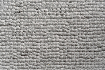Close-up of a textured gray rug.