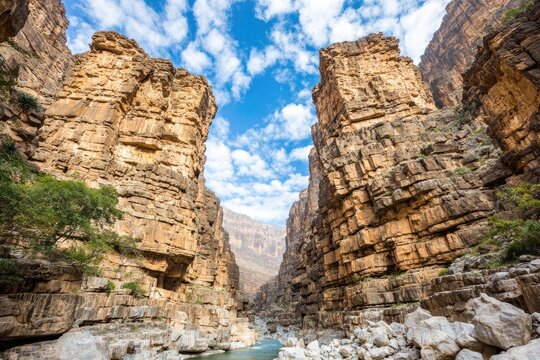 Canyon walls meet a sky filled with puffy clouds