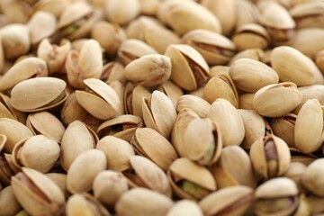Tasty unpeeled pistachios as background, top view flat lay background