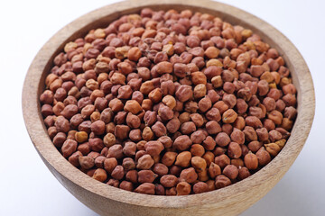 Indian food called Chickpeas or Chana  Harbara Chola Chole Chanu Buta| Konda in wooden bowl isolated on white background 