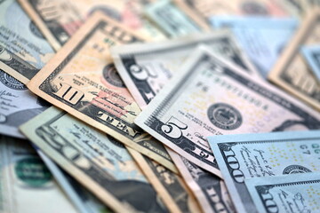 Big amount of different dollar bills close up. Hundred fifty twenty ten and five dollar banknotes