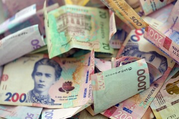 Big amount of Ukrainian hryvnia money bills. Pile of crumpled ukrainian banknotes
