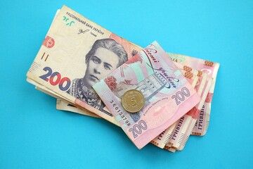Ukrainian money bills on light blue paper background