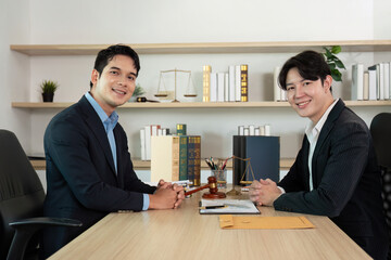 Legal Professionals. Two lawyers smiling at the camera in their office.