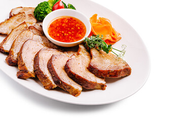 Deliciously prepared sliced pork with fresh vegetables and dipping sauce