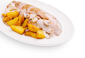 Delicious roasted chicken with creamy sauce and crispy potatoes served at dinner