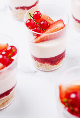 Delicious dessert cups with layers of cream, fruit, and crust on display