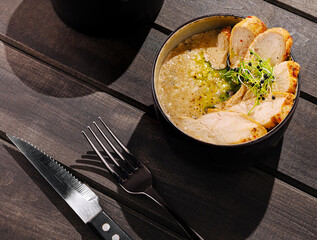 Delicious grilled chicken served with savory sauce on wooden table