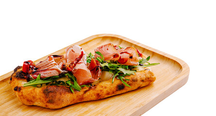Flatbread topped with fresh greens and cured meat, in a modern style
