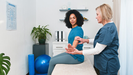 A Senior Physiotherapist Provides Expert Rehabilitation Guidance to a Young Black Client During a...