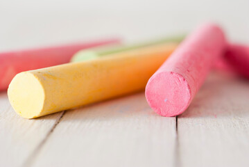 Chalks on white wooden table, front view
