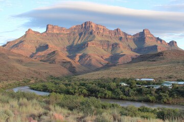 Mountain range overlooking a river valley at dawn