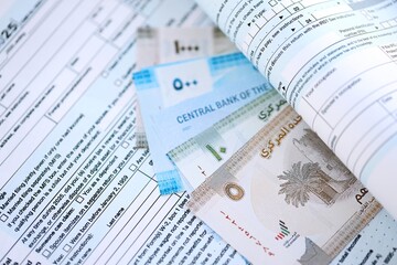 United Arab Emirates dirham money bills on tax form. Taxation and accounting concept