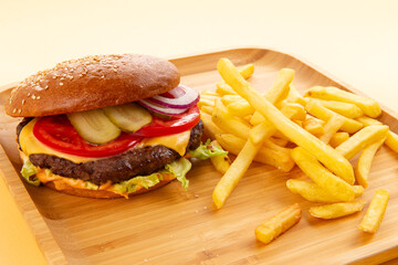 Perfect hamburger, classic burger, american cheeseburger with cheese and fries.