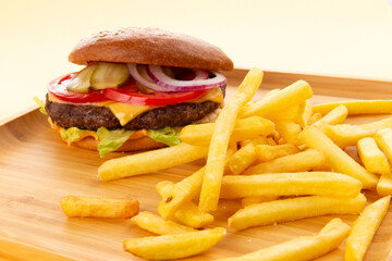 Perfect hamburger, classic burger, american cheeseburger with cheese and fries.