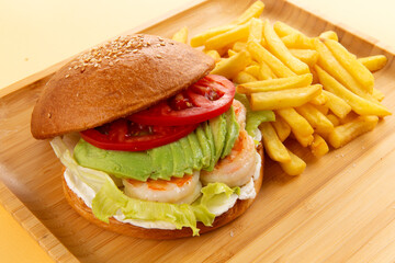 Shrimp and avocado sandwich. Burger. and fries.