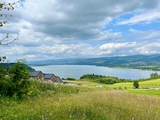 Traditional modern houses near Czorsztynskie lake with Tatra mountain background. Concept: rural lifestyle, eco living, authentic travel.	
