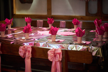A table set for a girl's birthday in pink tones