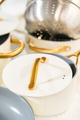 Cookware Ensemble with Gold Handles and Lids