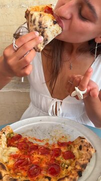 Experience a delicious pizza eating adventure in a warm and cozy dining setting