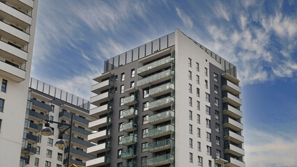 Exterior of ​​modern houses in new area of the city. Architectural detail of windows, balconies. Real estate, residential apartment and office building architecture